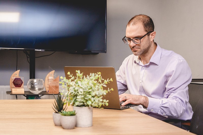 Brett On His Laptop Beside The Awards Brett On His Laptop Beside The Awards