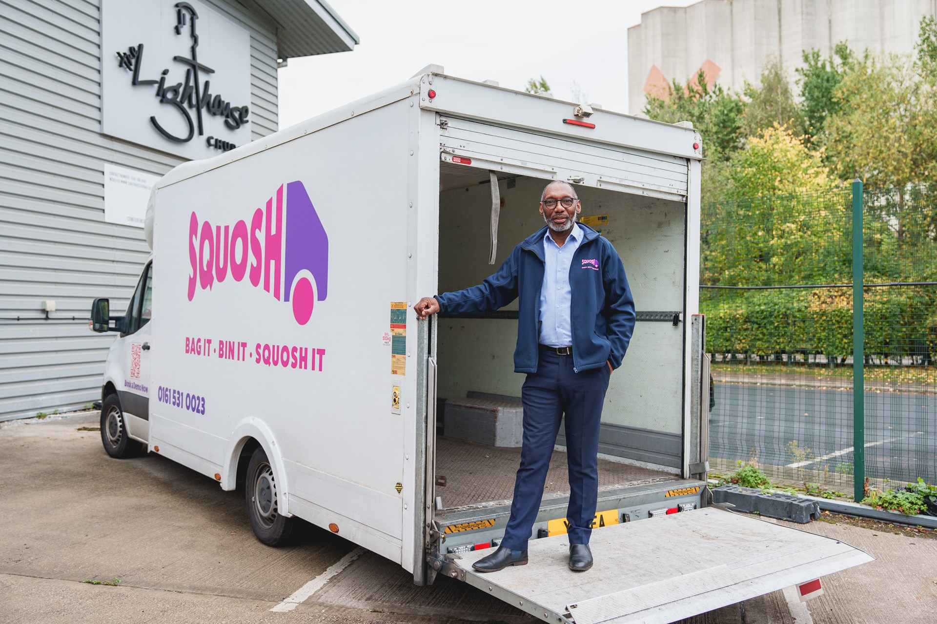 Eric McBean, Squosh compacting stood on his innovative waste compacting van, talking about growth support from Green Economy